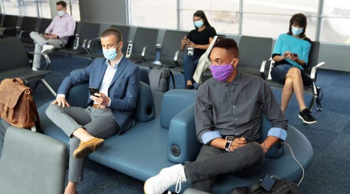 Airline travelers wear masks