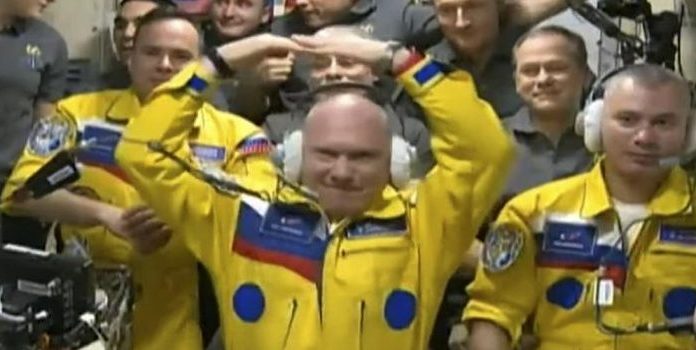 Russian cosmonauts wearing yellow and blue uniforms creates questions
