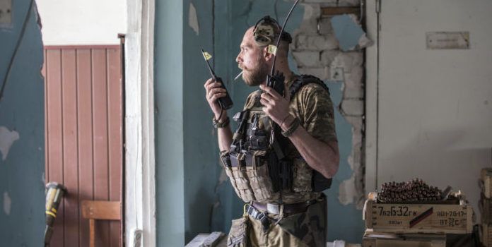 A Ukrainian soldier holds radios on the front line in Severodonetsk./ PHOTO: Associated Press