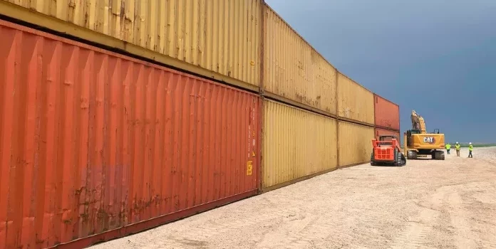 Shipping containers at border wall