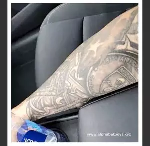 Red flashes a tattoo sleeve