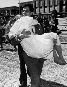 Former KKK leader Louis Beam carries his wife outside the courtroom after being acquitted of sedition. 