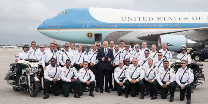 Trump poses with police officers in front of Air Force One