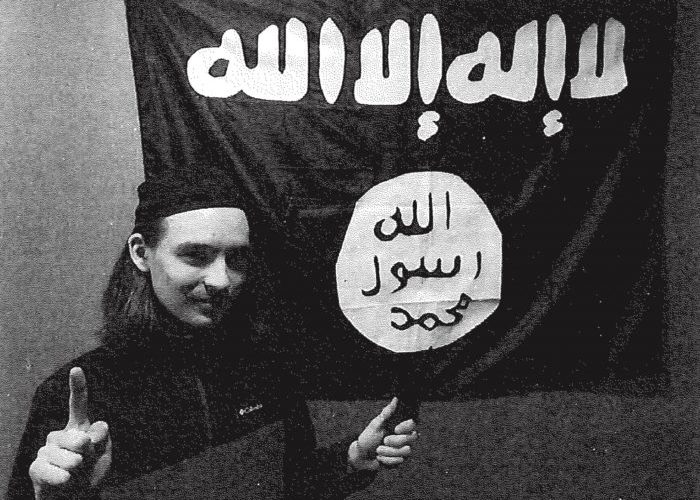 This picture of Alexander Scott Mercurio was taken by an FBI informant, who also gave Mercurio the ISIS flag in the background. PHOTO: DOJ