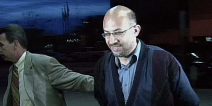 Sami Al-Arian is led in handcuffs to FBI headquarters in Tampa, Fla., Thursday, Feb. 20, 2003, following his arrest. PHOTO: AP