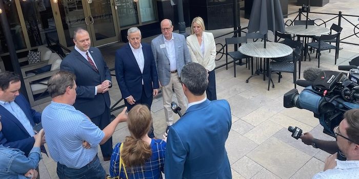 NCGOP Chairman Jason Simmons (far left, with tie), RNC Chair Michael Whatley, Rep. Dan Bishop and former Fla. AG Pam Bondi talk to Charlotte reporters about their election integrity plans for 2024. PHOTO: Ken Silva