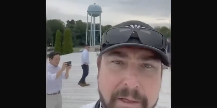 Former Navy Seal sniper Rep. Eli Crane shows the water tower while standing on the roof where Thomas Crooks shot at Donald Trump. PHOTO: Screenshot from congressional hearing