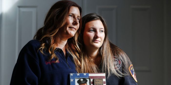 Pamela Yarosz and her daughter Capri are shown with a photo of New York firefighter Christopher Michael Mozzillo