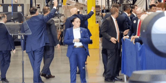 A Secret Service Agent keeps watch as former President Donald Trump pumps his fist in the background during a speech in Mint Hill, N.C. / PHOTO: Ben Sellers, Headline USA - All RIGHTS RESERVED