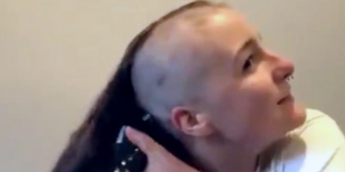 Woman shaving head