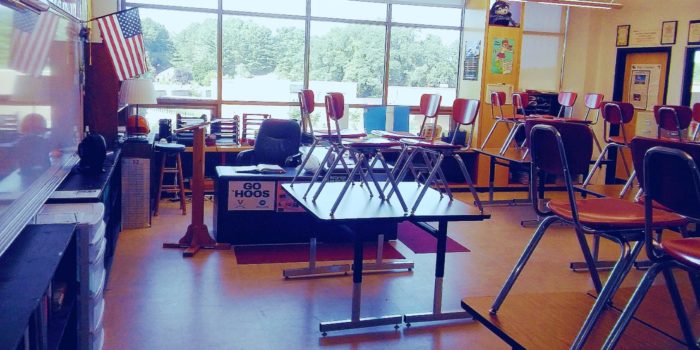 Desk chairs sit atop the tables in an empty high school classroom. / PHOTO: Ben Sellers, Headline USA (all rights reserved)