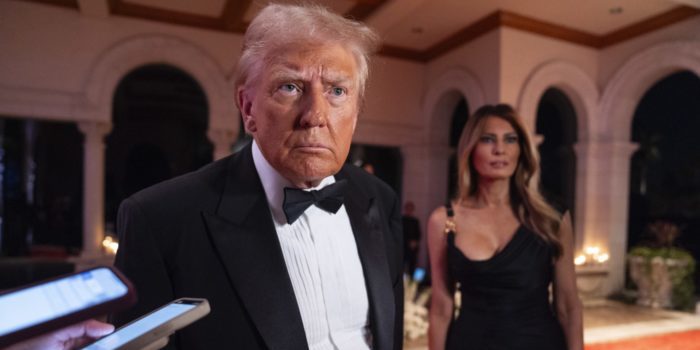 Melania Trump looks on as President-elect Donald Trump speaks to reporters before a New Year's Eve party at Mar-a-Lago, Tuesday, Dec. 31, 2024, in Palm Beach, Fla. (AP Photo/Evan Vucci)