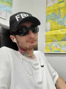 Bobby in Todd Rhode’s shop wearing an FBI hat.